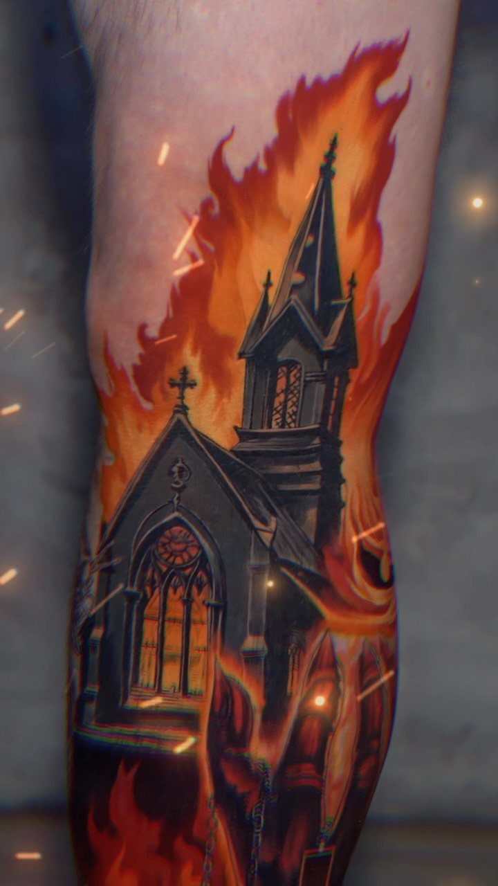 6 Burning Church Tattoo Ideas for Dark, Dramatic Ink 3 A realistic tattoo of a dark gothic church engulfed in bright orange and red flames on skin.
