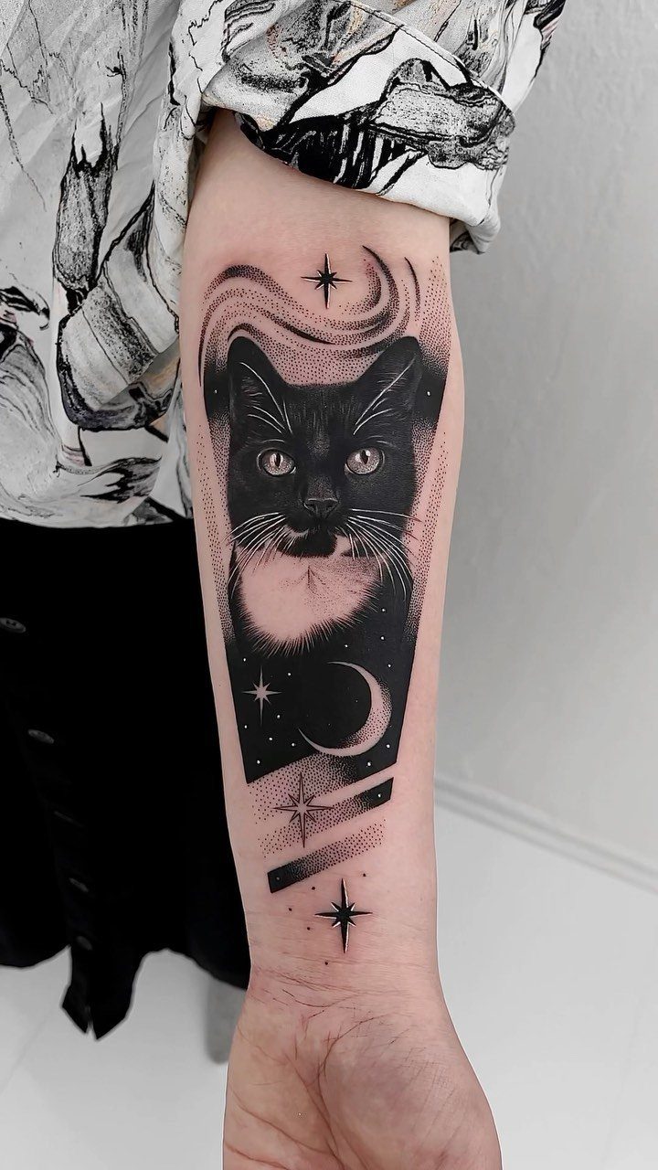 Cat Tattoo with Pattern: 8 Bold Design Ideas to Consider 6 A black ink tattoo of a cat face surrounded by stars and a crescent moon.