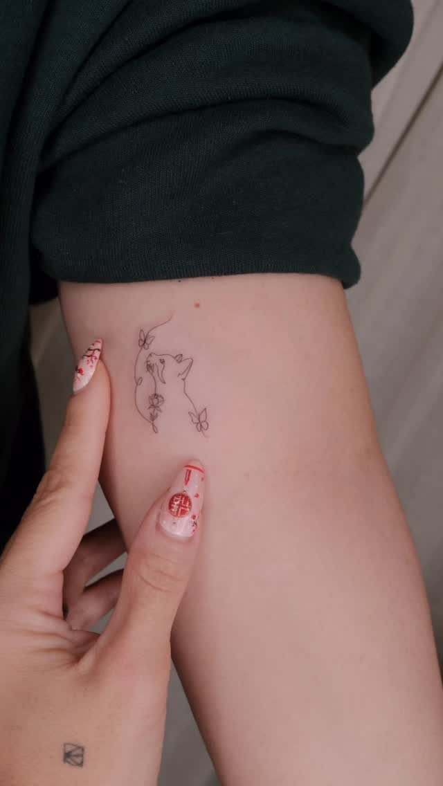 Cat Tattoo with Pattern: 8 Bold Design Ideas to Consider 5 A minimalist fine line cat silhouette tattoo on a person's leg.