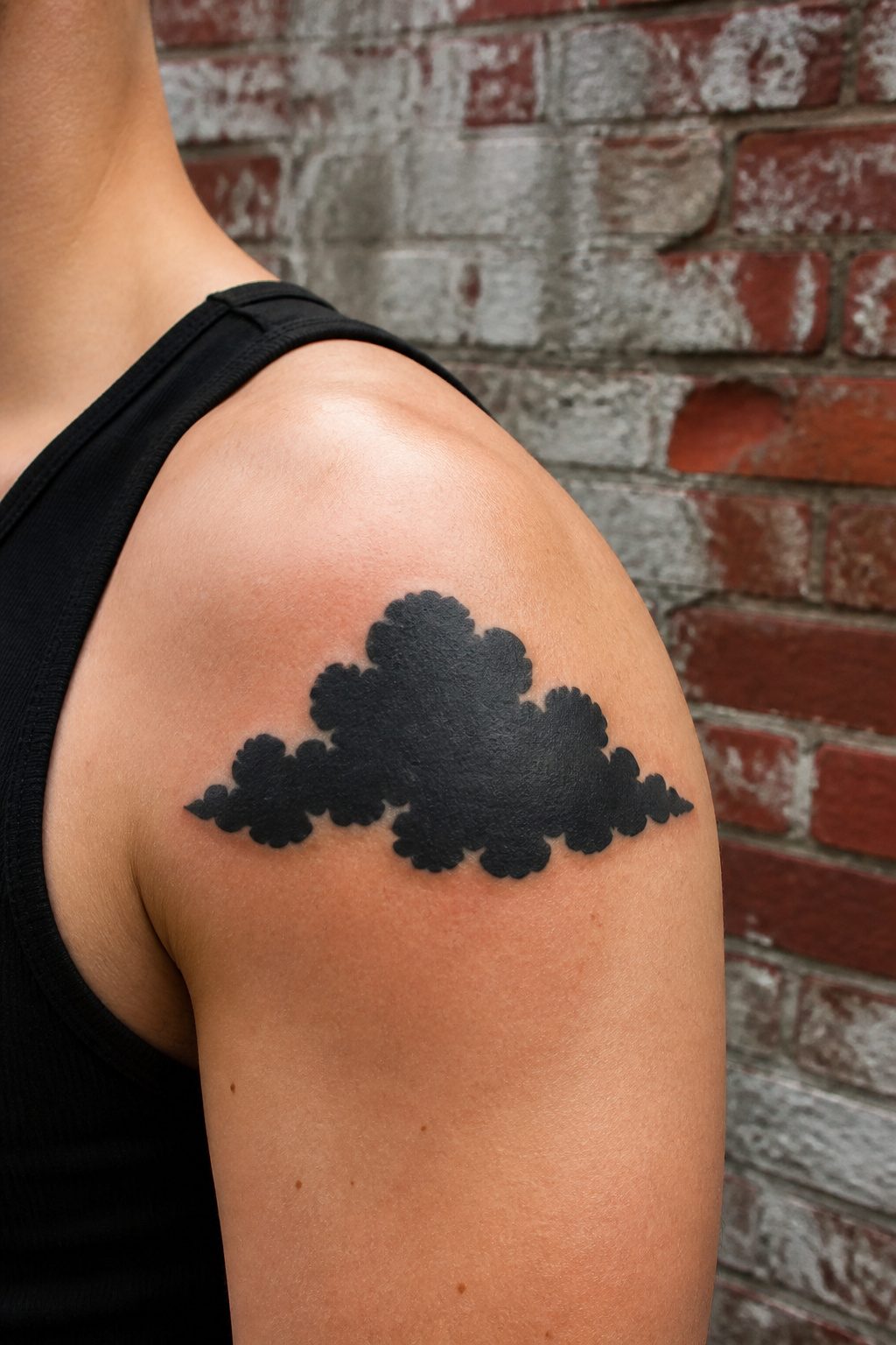 40 Cloud Tattoo Ideas for 2026: Japanese, Storm, Sleeve & More 9 Heavy black cloud tattoo with solid graphic edges.
