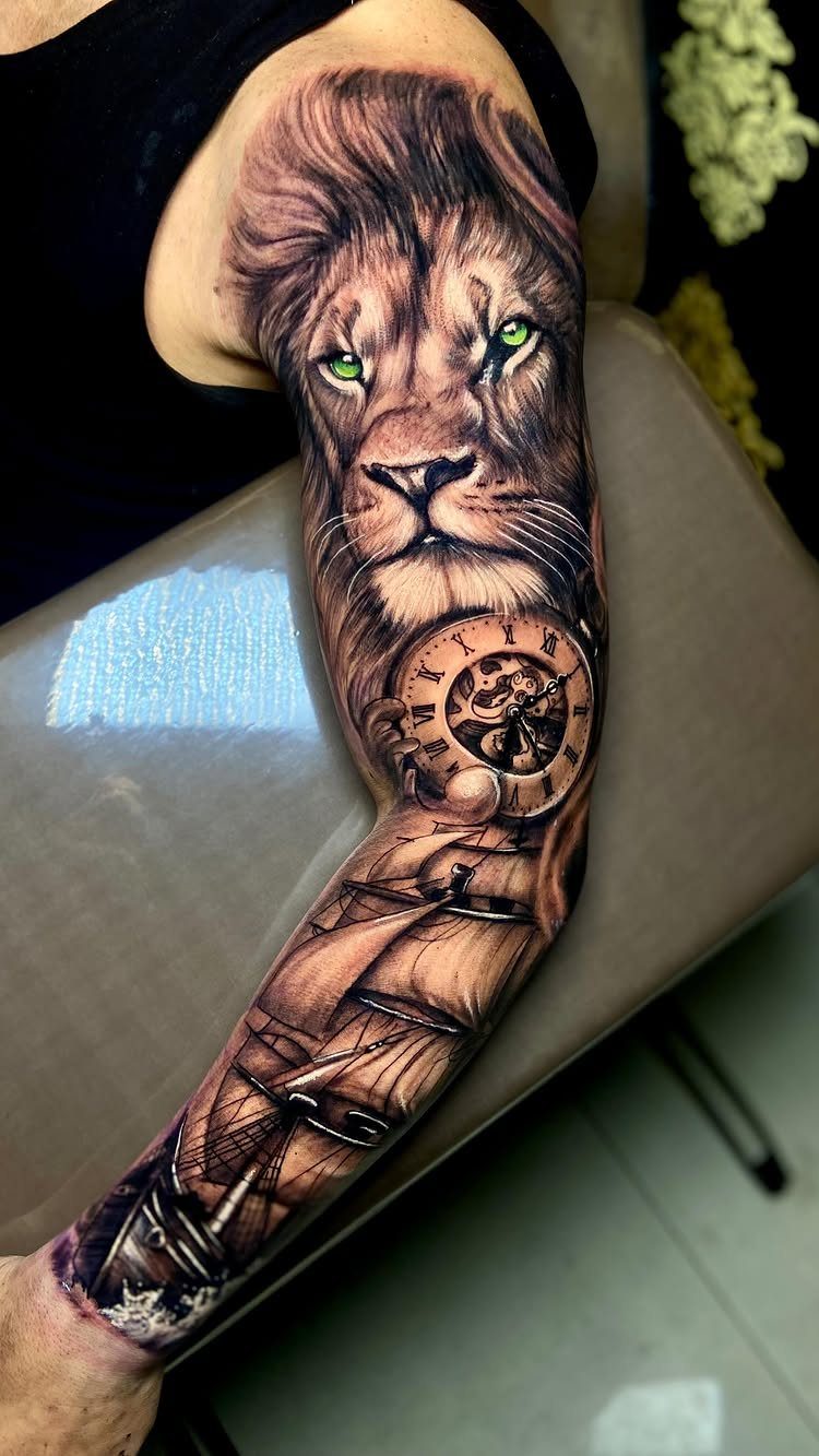 8 Full Arm Tattoo Ideas for Men and Women 7 A detailed full arm tattoo featuring a lion, a clock, and a sailing ship.