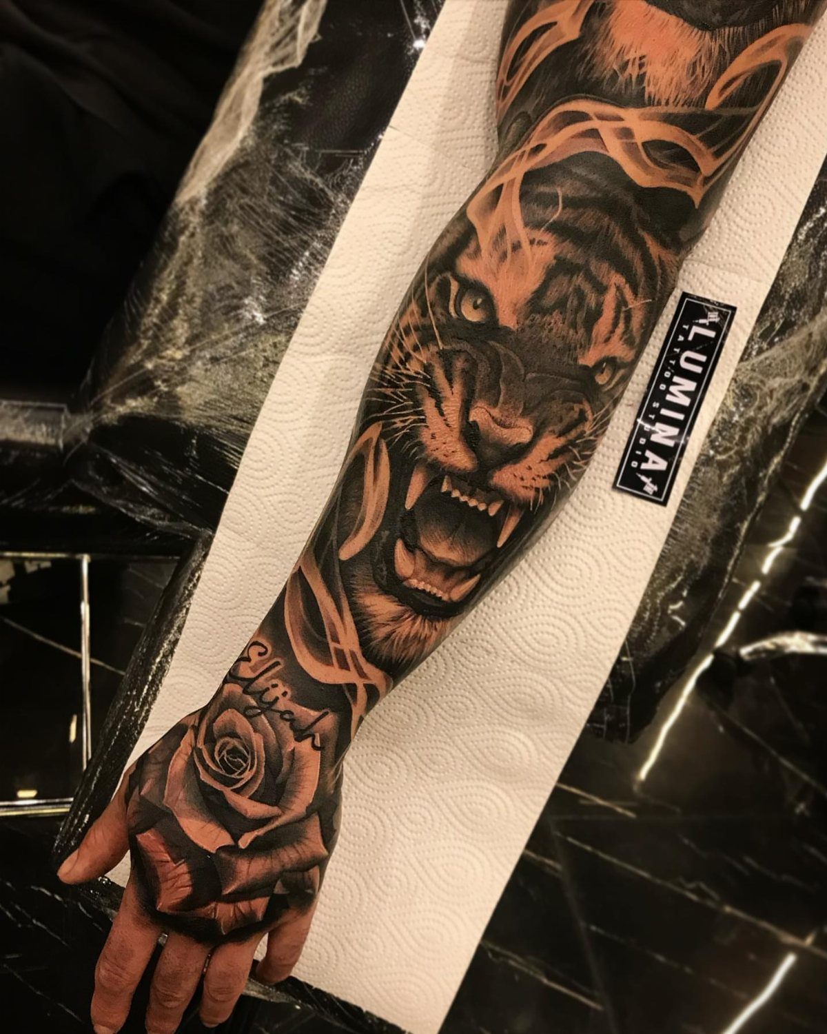8 Full Arm Tattoo Ideas for Men and Women 5 A detailed black and grey tattoo sleeve featuring a roaring tiger face and a rose.