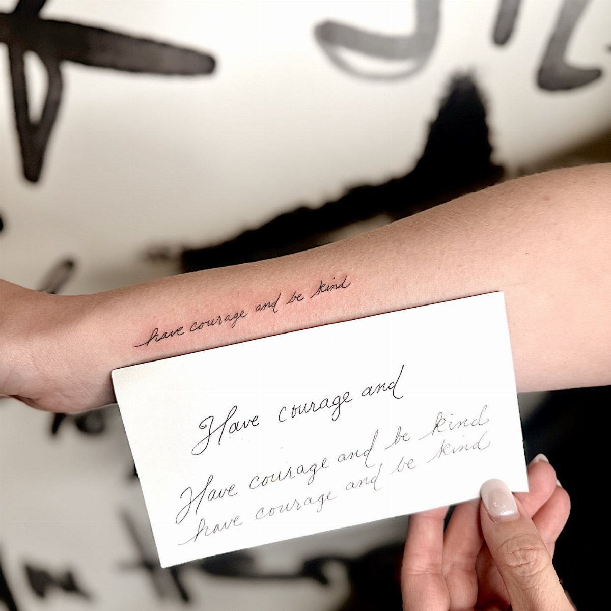 Have Courage and Be Kind Tattoo: 6 Designs Worth Committing To 3 A forearm displaying a delicate script tattoo reading have courage and be kind.