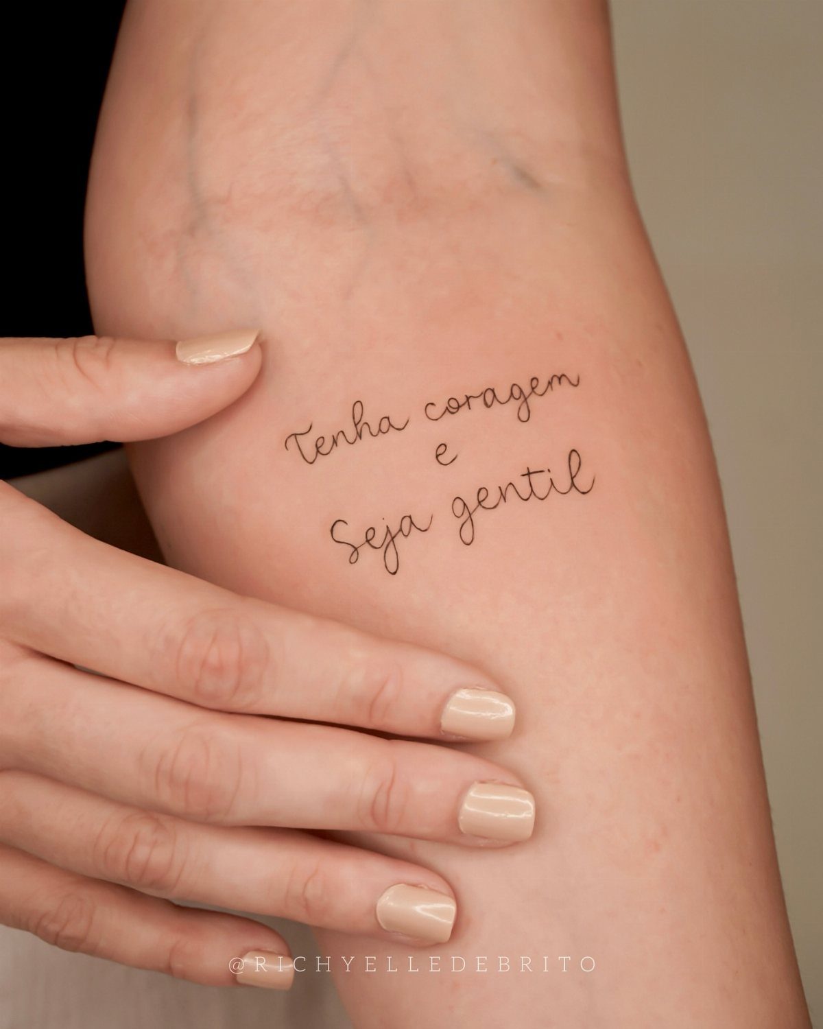 Have Courage and Be Kind Tattoo: 6 Designs Worth Committing To 6 A delicate script tattoo on a person's arm reading Tenha coragem e Seja gentil.