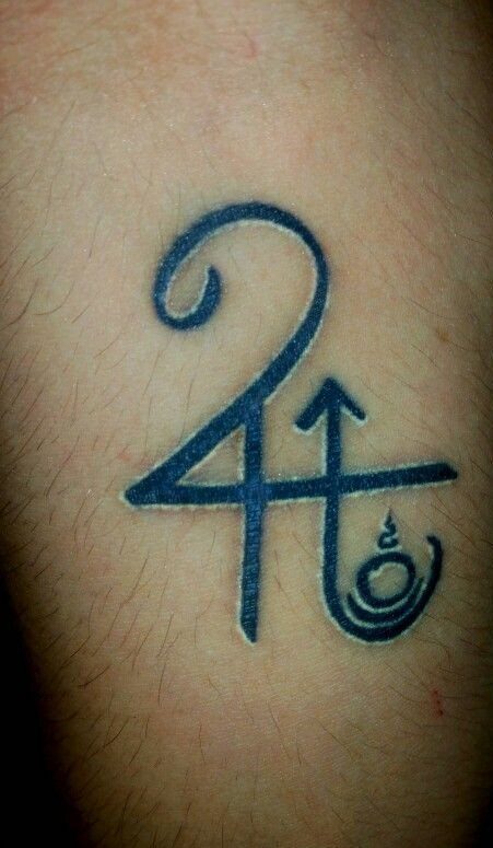 5 Jupiter Tattoo Ideas for Celestial Ink That Stands Out 3 A black ink tattoo of the Jupiter astrological symbol on human skin.
