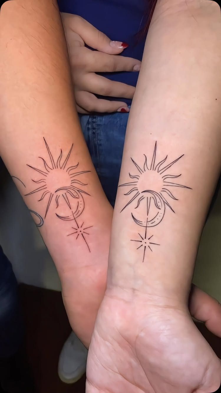 9 Minimalist Couple Tattoo Ideas Unique and Subtle for Lasting Ink 1 Two forearms displaying matching minimalist sun and crescent moon tattoos in black ink.