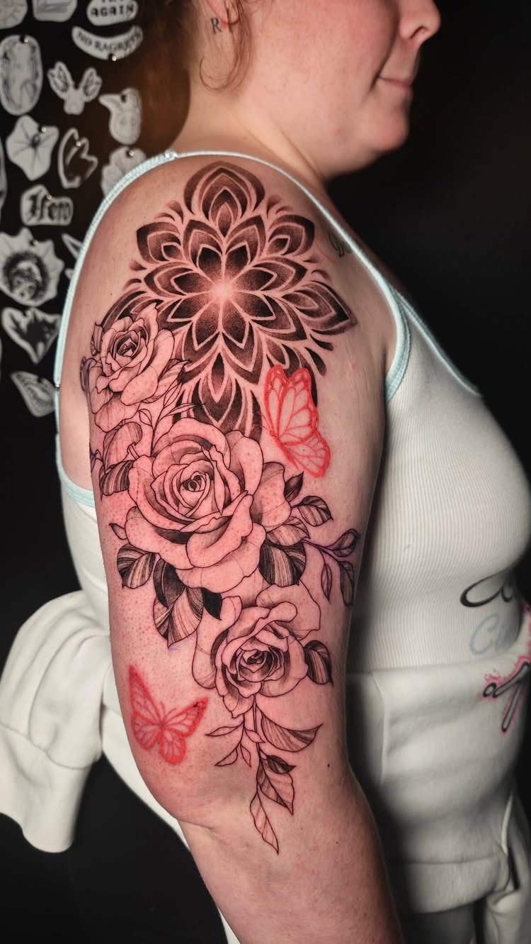 7 Rose with Pattern Tattoo Design Ideas for Ink That Stands Out 2 Black ink rose and mandala tattoo with red butterflies on a person's shoulder.