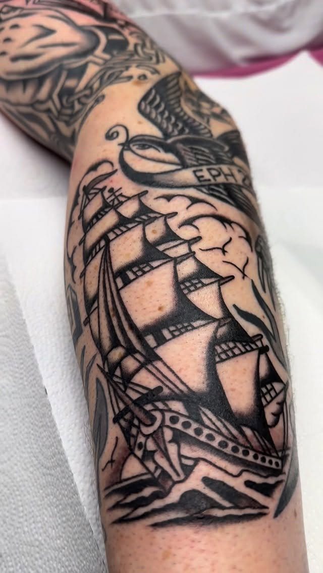 16 Ship Tattoo Ideas in Anchor, Viking, Pirate and Seascape Styles 7 A traditional black and grey sailing ship tattoo on a person's forearm.