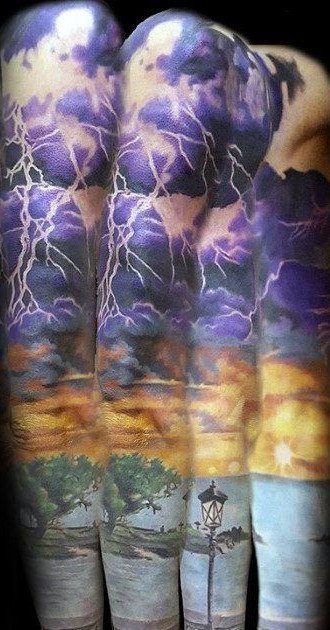 Storm Tattoo: 8 Nature-Inspired Designs for Your Next Ink 5 A detailed leg tattoo showing purple storm clouds, lightning bolts, and a sunset landscape at the bottom.