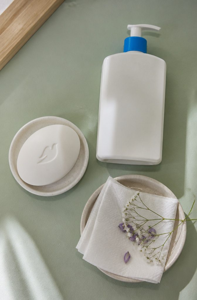Tattoo Healing: A 5-Step Guide to the First Month 7 Dove Sensitive Skin Beauty Bar placed next to a clean towel.