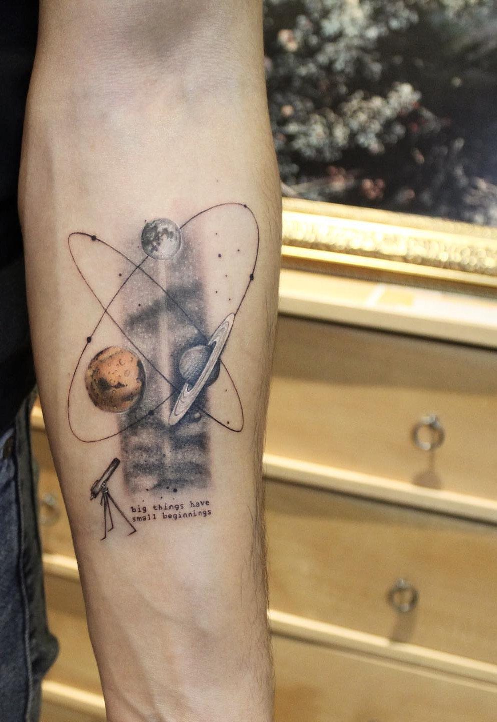 7 Telescope Tattoo Ideas for Every Space and Style 3 A forearm tattoo depicting a small telescope, planets, and orbital rings with stars.