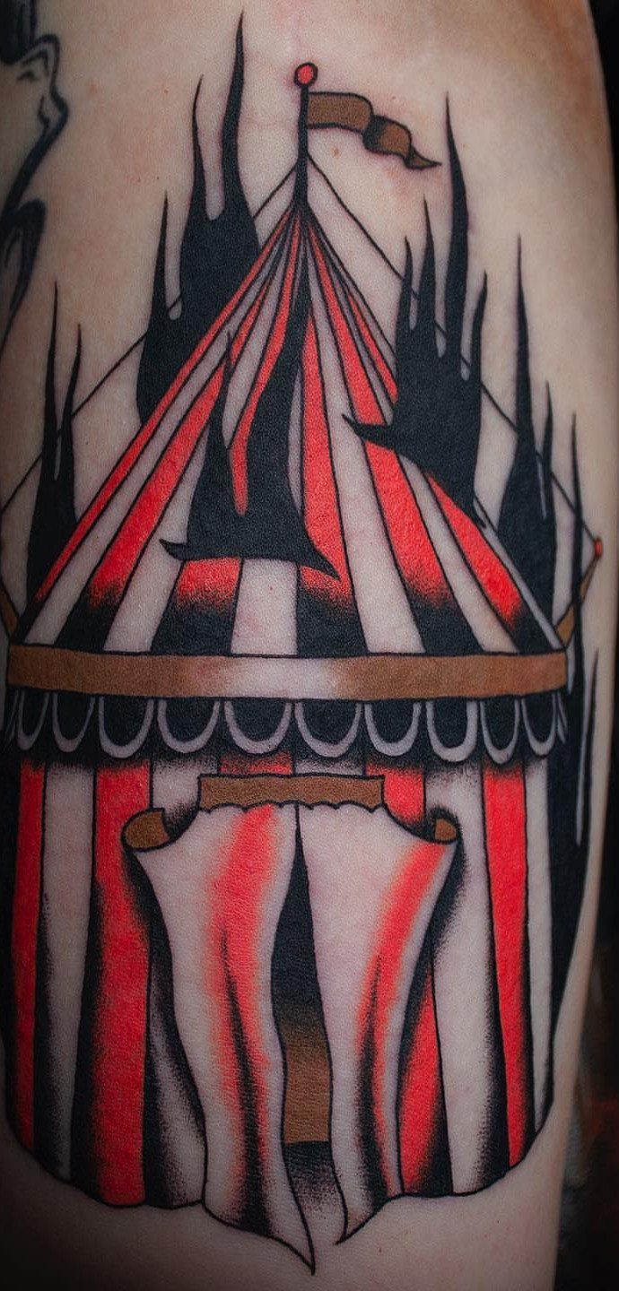 6 Tent Tattoo Ideas for Camping and Circus Styles 4 A red and white striped circus tent tattoo with black shading on skin.