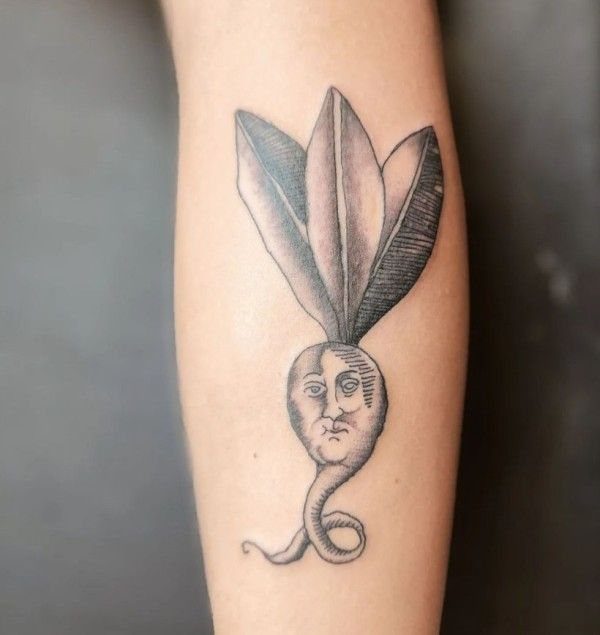 The Most Beautiful Radish Tattoo: 8 Designs for Your Next Ink 3 A black ink tattoo of a round radish with a human face on an arm.