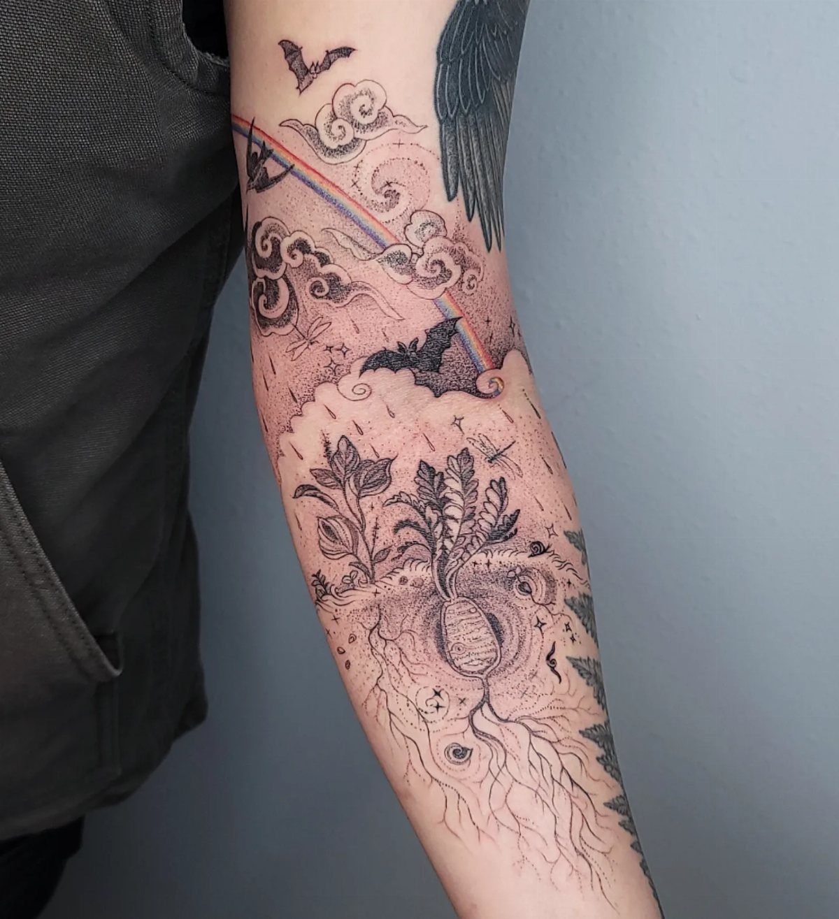 The Most Beautiful Radish Tattoo: 8 Designs for Your Next Ink 5 A fine-line tattoo on an arm depicting a radish, clouds, bats, and a rainbow.