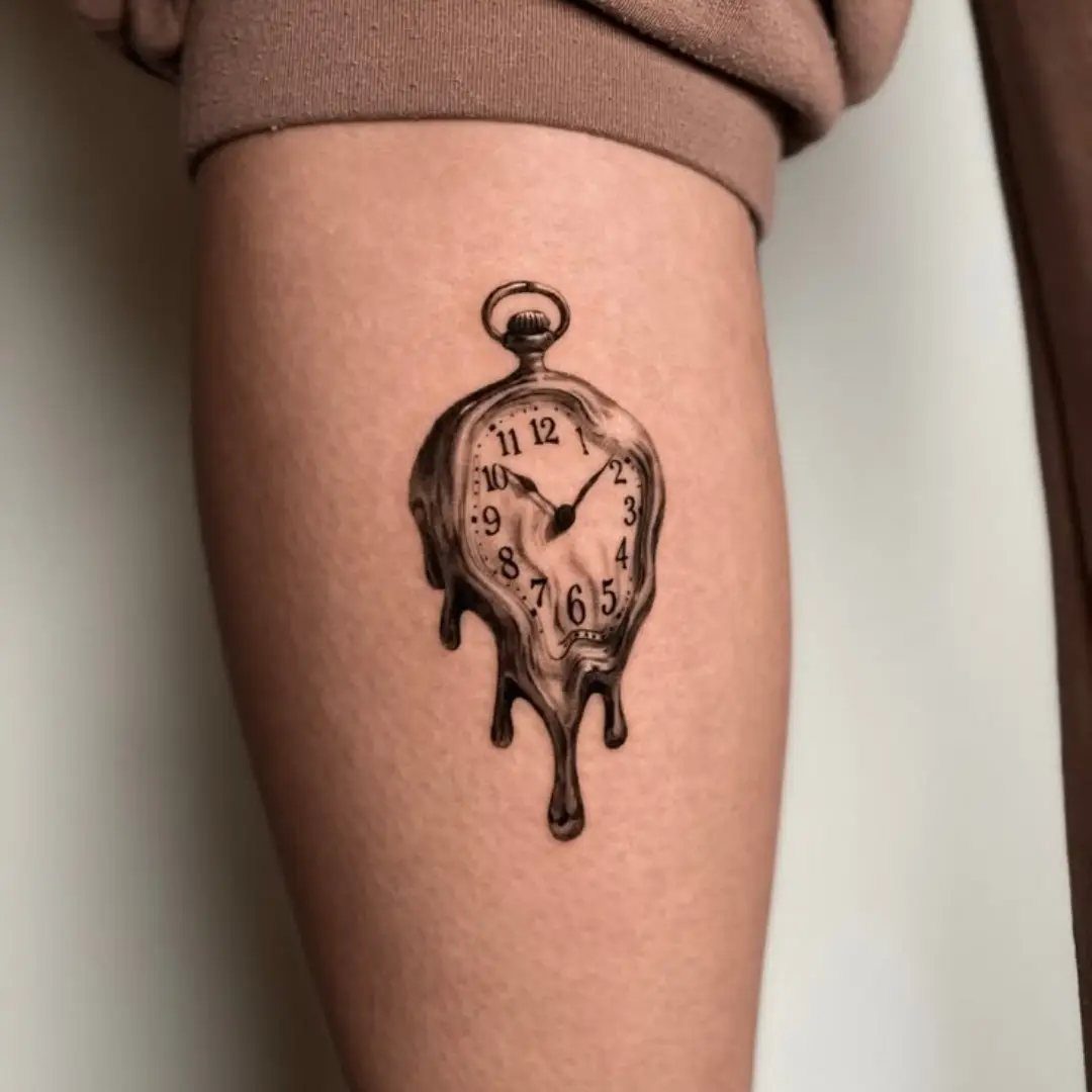 Time Waits for No Man Tattoo: 6 Designs That Mark the Moment 5 A black and grey tattoo of a melting pocket watch on a person's leg.