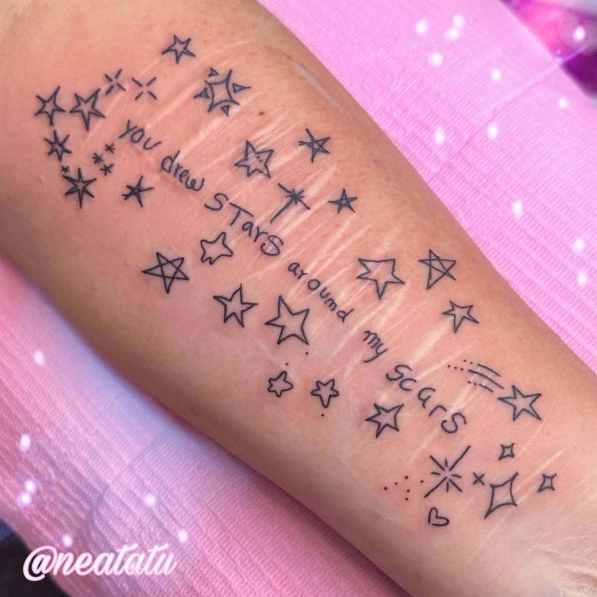 6 Twinkle Star Tattoo Ideas for Light, Sparkly Ink 1 Black ink star tattoos and handwritten text winding around scars on a person's arm.