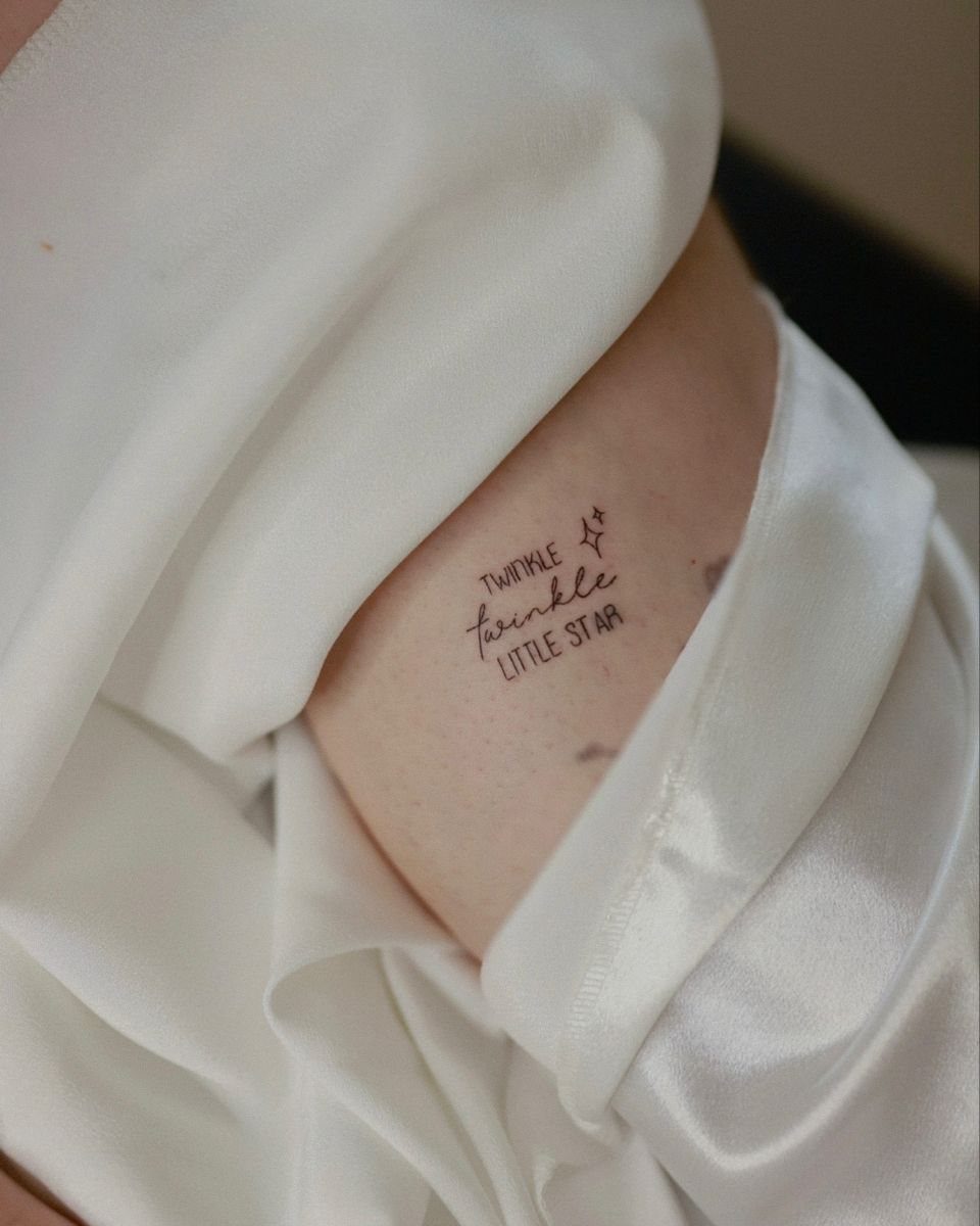 6 Twinkle Star Tattoo Ideas for Light, Sparkly Ink 4 A small black ink tattoo of the text twinkle twinkle little star with a tiny star.