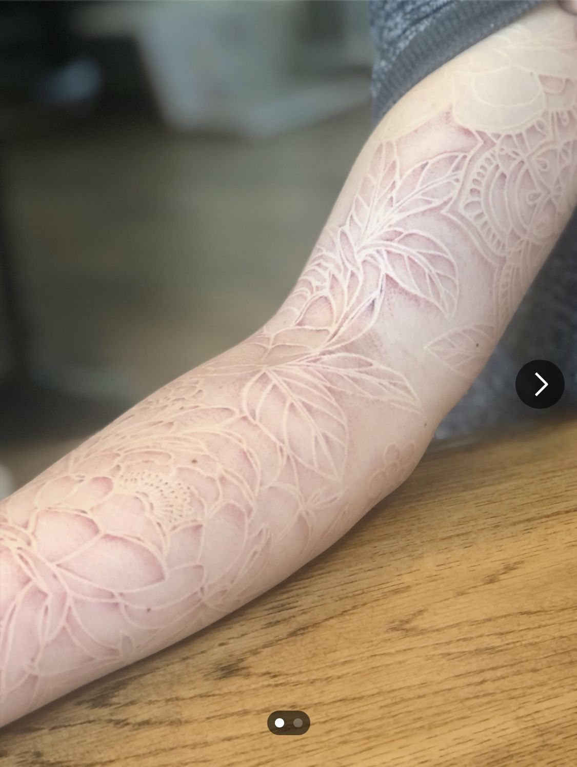 White Ink Water Lily Tattoo: 7 Ideas for Subtle Floral Ink 5 A detailed white ink tattoo sleeve featuring water lily and floral patterns on a person's arm.